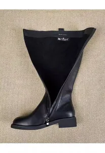 Interior detail of elegant black leather knee-high knight boot with side zipper closure