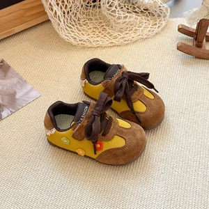Detailed view of yellow and brown toddler girls' floral sneakers with soft breathable soles