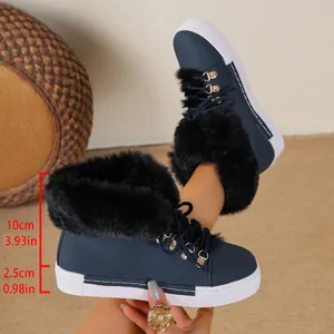 Close-up detail of navy blue winter snow boots featuring a thick black faux fur collar and lace-up