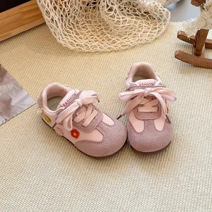 Detailed view of pink toddler girl sneakers featuring floral embroidery and soft soles
