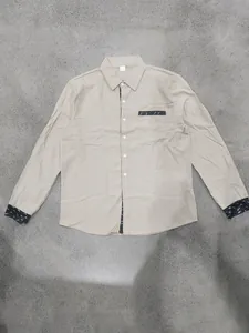 Casual beige linen long-sleeve shirt featuring patterned cuffs and a chest pocket detail