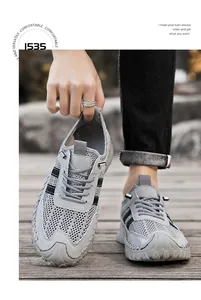 Detail of grey mesh breathable outdoor sneakers for men in a lifestyle setting
