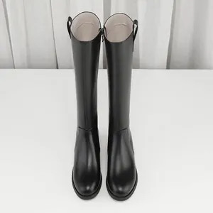 Close-up front view of elegant black knee-high leather riding boots with pull tabs