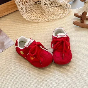 Detailed view of red toddler sports shoes with floral embroidery and soft soles