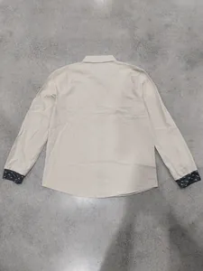 Back view of a casual khaki linen long sleeve shirt featuring bird print contrast cuffs