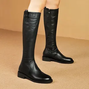Black leather knee-high knight boots with side zipper for a sleek autumn look.
