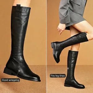 Minimalist black leather knee-high riding boots for women featuring a sleek fit design
