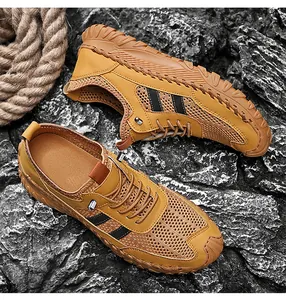 Detailed macro view of men's tan breathable mesh outdoor sports shoes on rocks