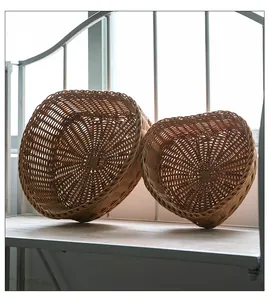 Detailed view of two rustic heart-shaped woven baskets for snacks on a light wooden shelf