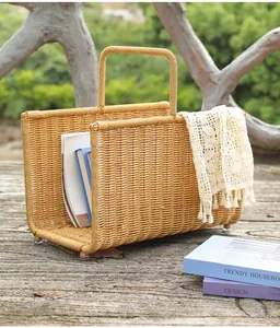 Outdoor hand-woven rattan style magazine storage basket styled with vintage books