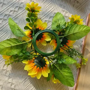 Detailed back view of artificial sunflower candle ring showing green plastic base