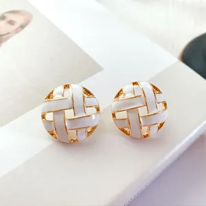 Vintage round hollow white enamel stud earrings with golden woven pattern detail