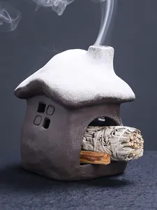 Close-up detail of a ceramic snowy house incense burner for burning sage and Palo Santo