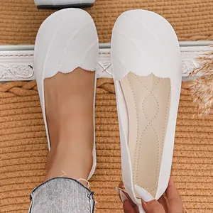 Close-up detail of white breathable fly-knit round toe loafers for women