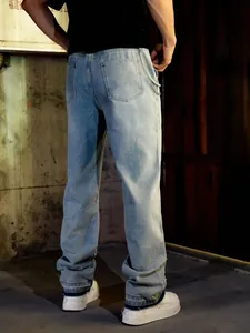 Detail view of men's loose straight jeans with pearls and rhinestones on hem