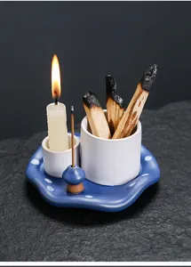 Close-up of mushroom ceramic incense burner set with lit candle and palo santo sticks