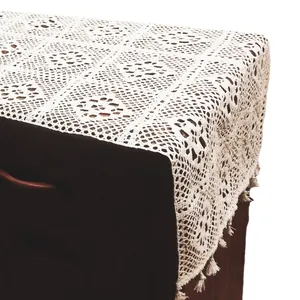 Elegant vintage white crochet lace table runner with openwork floral pattern and fringe