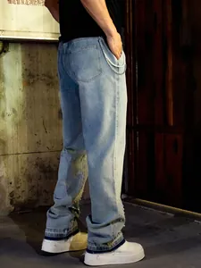 Detail view of men's wide-leg jeans with pearl embellishments at the hem