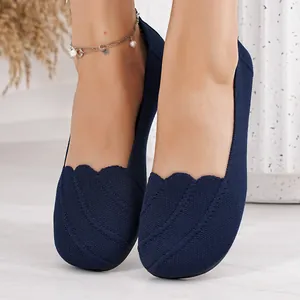 Close-up view of dark blue breathable fly-woven flats with scalloped edge design