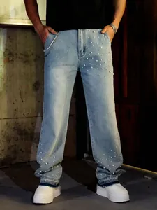 Detailed view of men's loose straight denim jeans with white pearl bead embellishments