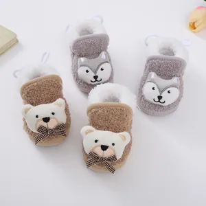 Close-up of cute cartoon bear and fox baby fleece-lined warm toddler shoes