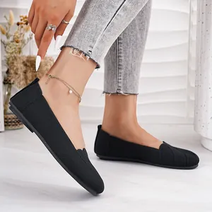 Close-up of breathable black fly-woven flat shoes with comfortable round toe design.