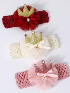 Detail view of infant lace headbands featuring shiny glitter crowns and small pearl accents