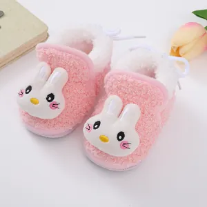 Close-up of pink fuzzy baby winter shoes with soft plush lining and rabbit design