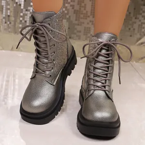Close-up of metallic silver combat boots with sequin details and chunky platform soles