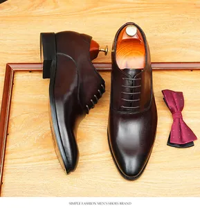 Detailed view of high-quality brown leather Oxford dress shoes with pointed toe