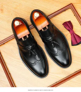 Close-up of black leather wingtip loafers with elegant tassels and brogue details