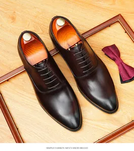 Top-down view of premium dark brown leather men's oxford shoes on wood surface.