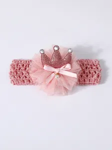 Close-up detail of a pink baby crown headband featuring a lace flower and pearl