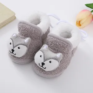 Detailed view of grey fleece baby booties with a cute cartoon animal face design