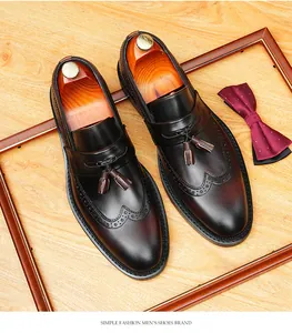Top view close-up of men's leather brogue loafers with tassel and burnished finish