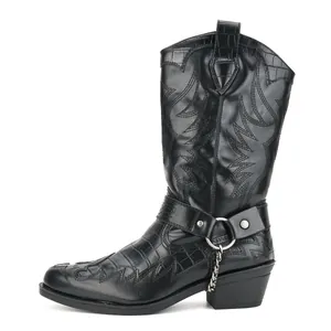 Detail view of black crocodile embossed Western boots with metal chain decoration.