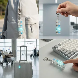 A detailed view of a transparent 4-key mechanical switch fidget keychain glowing blue.