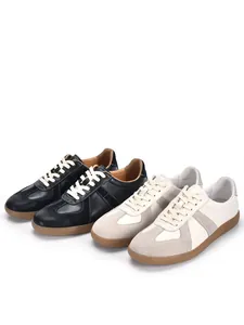 Detailed view of black and off-white leather German Army Trainers retro casual sneakers