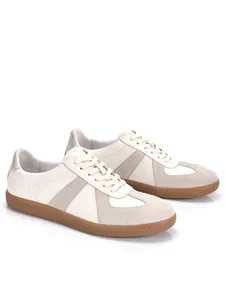 Close-up of men's retro GAT leather sneakers with suede overlays and gum soles.