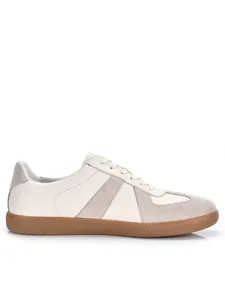 Side profile detail of retro white leather German Army Trainer sneakers with brown gum sole