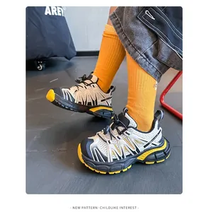 Detail of children's breathable hiking sneakers with yellow accents and non-slip sole