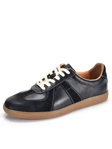 Side view of retro black leather German Army Trainers with classic gum sole finish