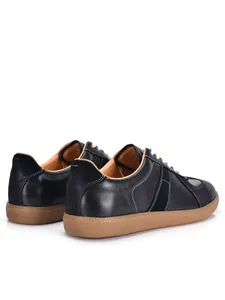Rear view of black leather retro GAT sneakers with gum sole and white stitching