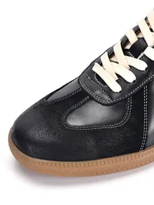 Detailed close-up of premium black leather retro German Army Trainer GAT sneakers
