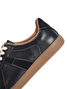 Close-up of black genuine leather GAT sneakers with classic gum sole and white stitching