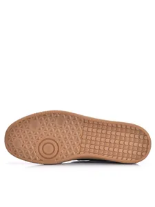 Detailed macro view of the anti-slip gum rubber outsole of a German Army Trainer shoe.