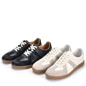Retro leather German Army Trainers for men in black and cream white with gum soles.