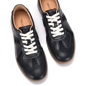 Classic retro men's black leather German army trainers featuring white laces and tan soles