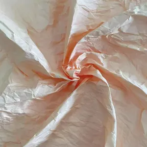 Detail showing the fine texture and gradient color of handmade rose dyed crepe paper