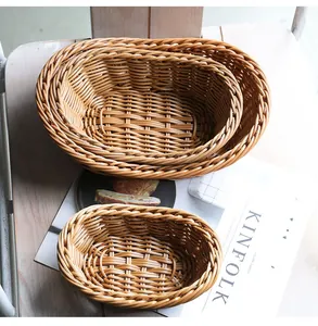 Set of three nesting oval imitation rattan woven baskets for fruit and bread storage